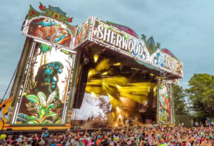 Photo of a colorful stage and full crowd in front of it at Electric Forest