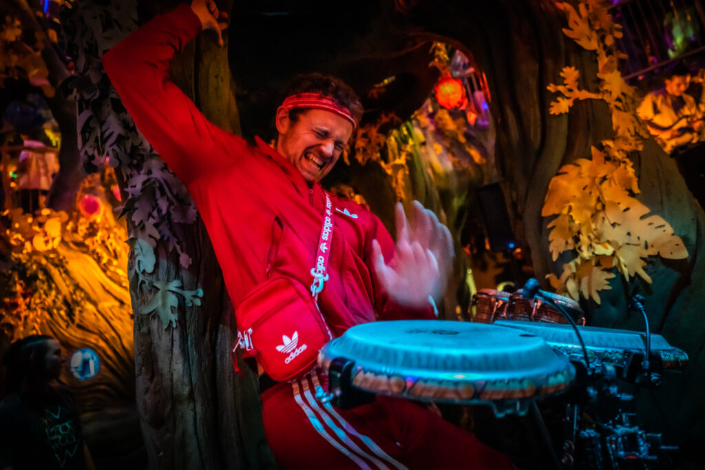 Man in red track suit playing drums