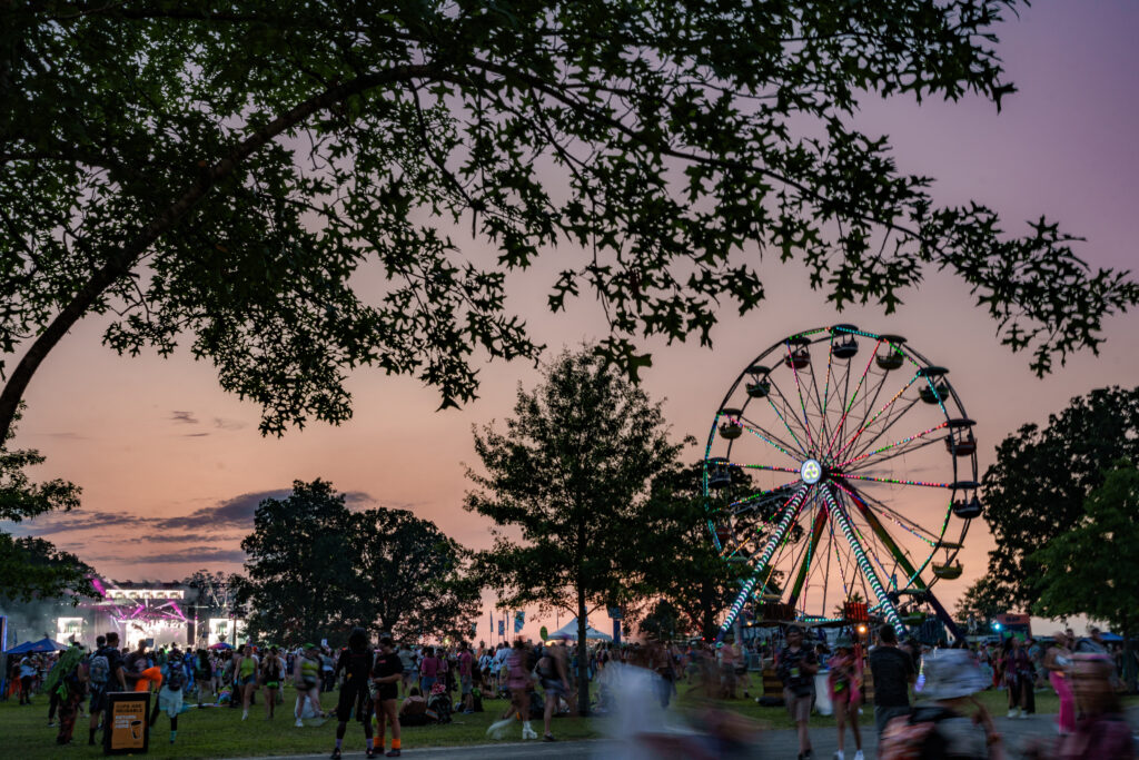 Photo of a ferris wheel at a festival at sunset