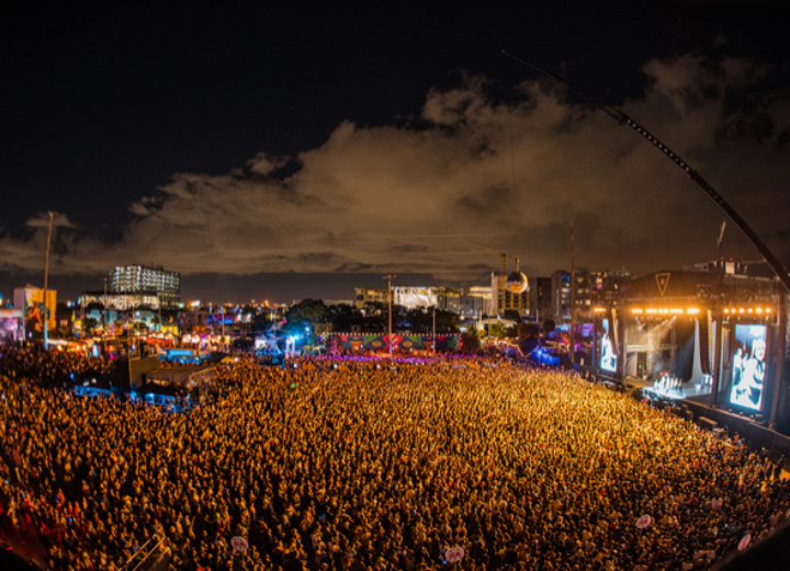 III Points Miami Music Festival: large crowd facing mainstage with glowing orange lights.