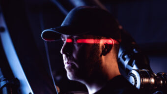 photo of man in a black hat with a red light across his face