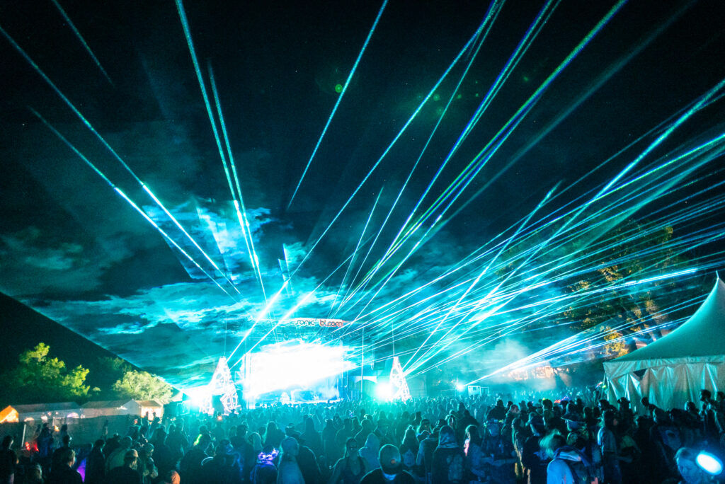 Lasers being shot out from the Sonic Bloom festival main stage.