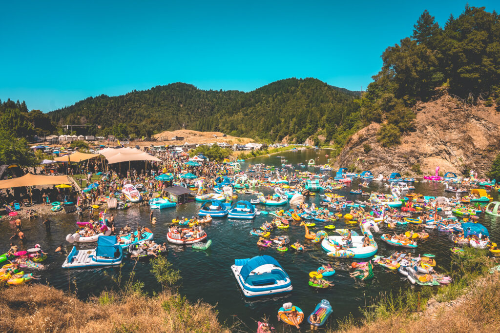 Photo of people and rafts on a lake.