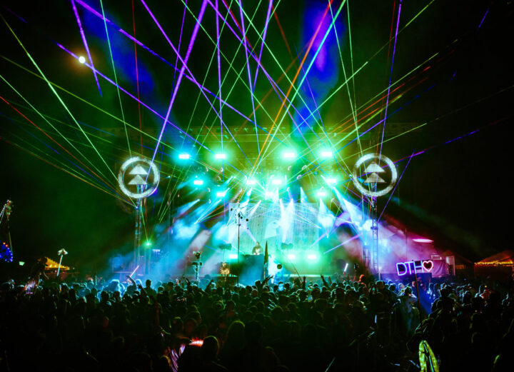 Photo of a festival stage with lasers.