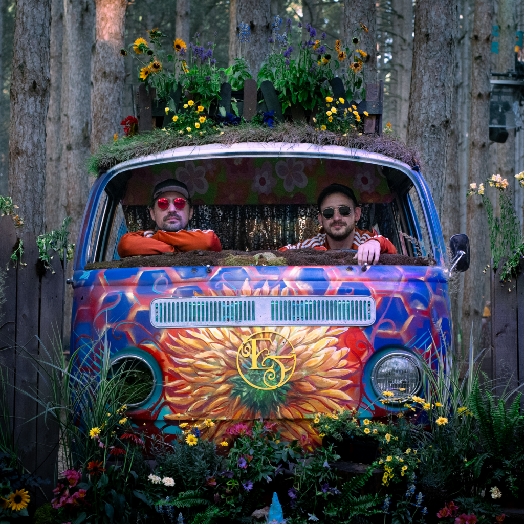 photo of two guys in a colorful van in the woods