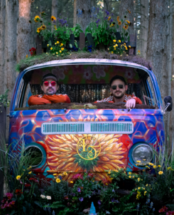 photo of two guys in a colorful van in the woods