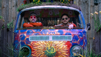 photo of two guys in a colorful van in the woods