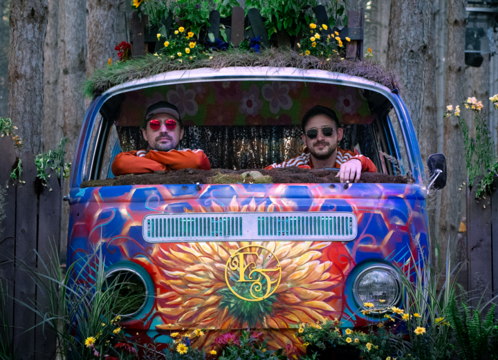 photo of two guys in a colorful van in the woods