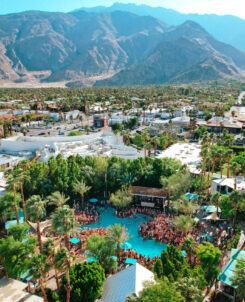 Photo of massive resport and pool in the daytime with mountains in the background