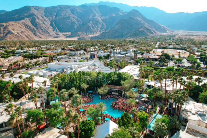 Photo of massive resport and pool in the daytime with mountains in the background