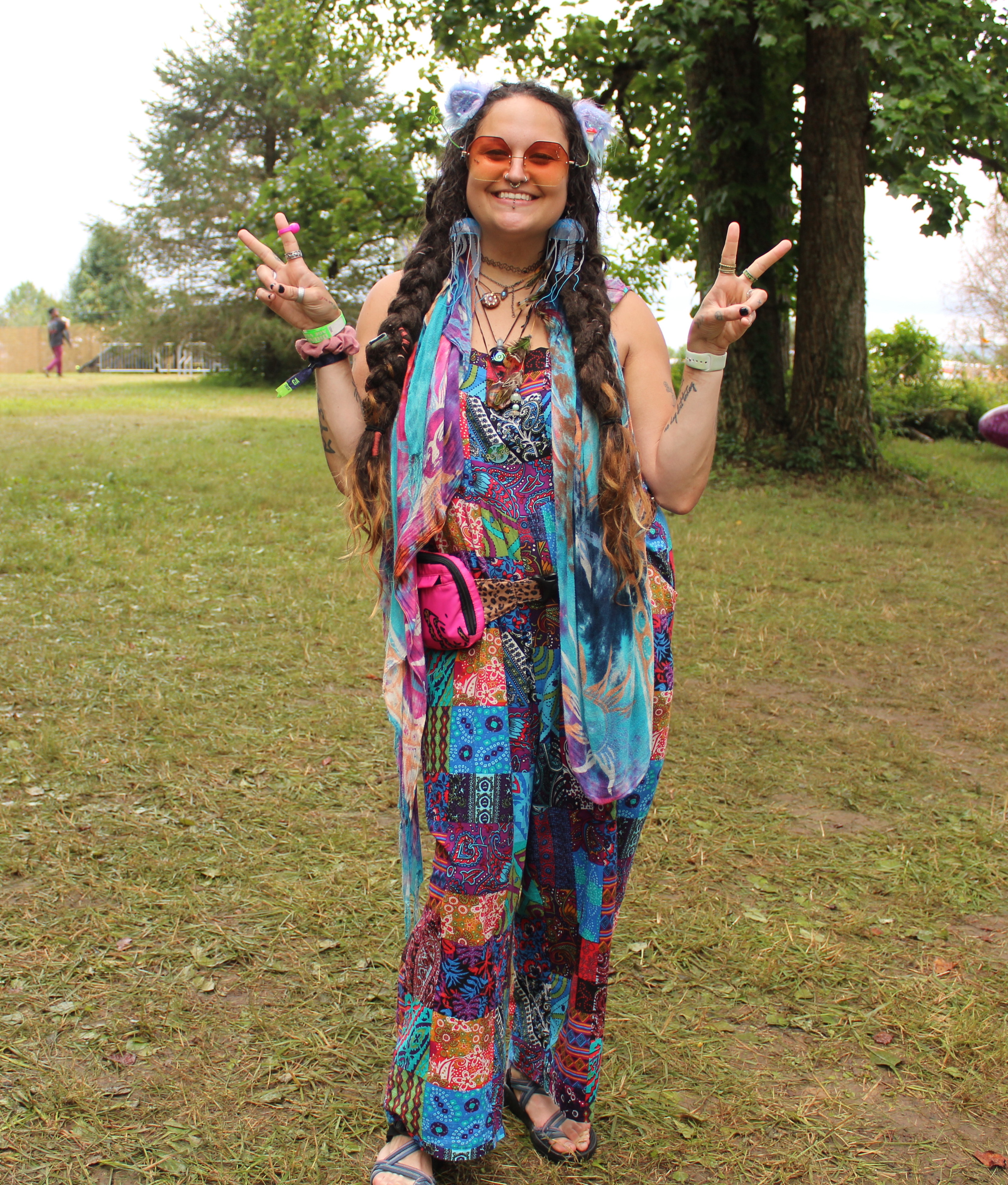 Festival fashion 2023: women wearing rainbow overalls, pashmina and cat ears