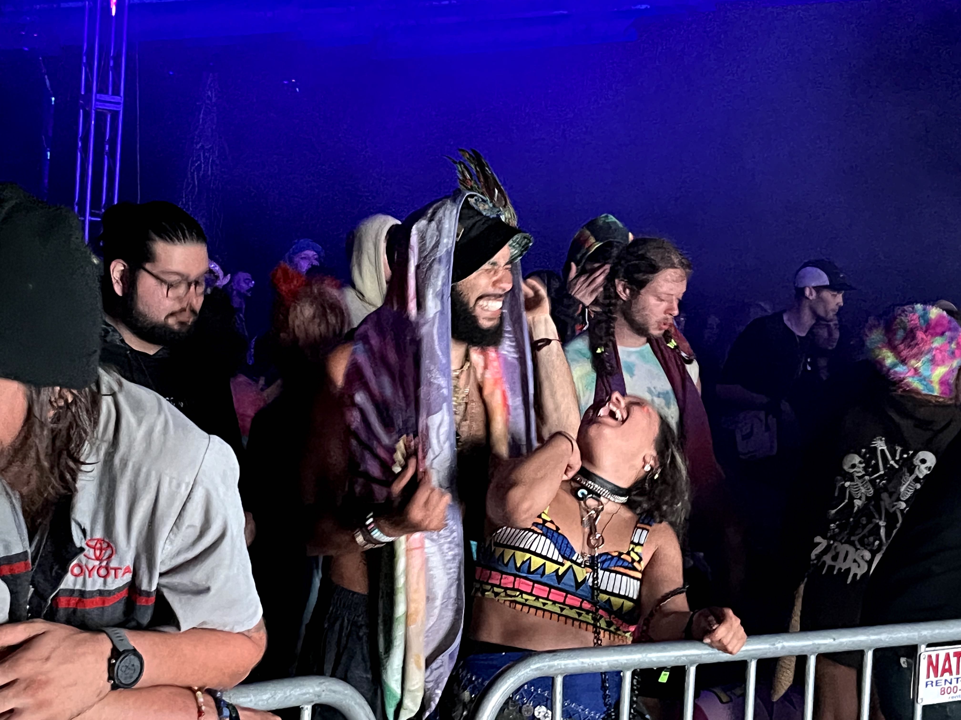 Festival fashion 2023: Couple sharing a happy moment at the rail.