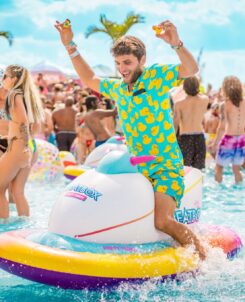 Imagine Music Festival pool party: man in duck shirt floating in pool