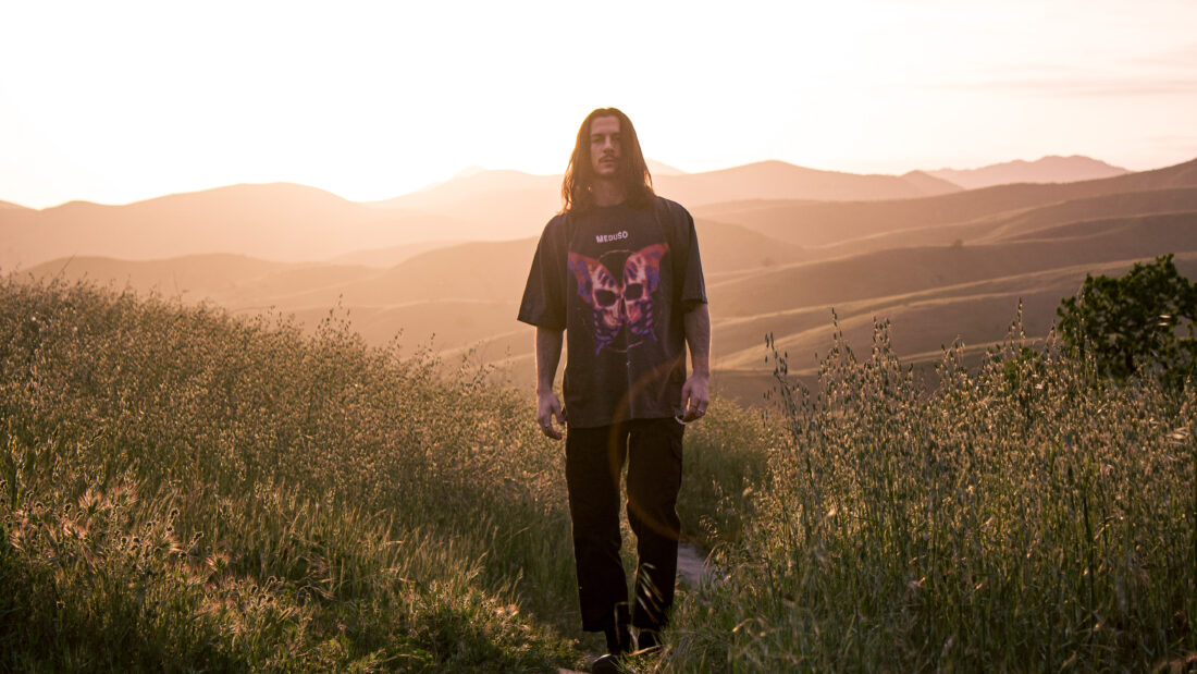 Meduso press shot: walking in grassy hills in California at sunset