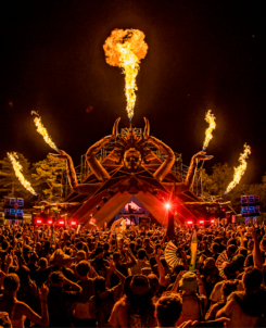 Elements Music and Arts Festival 2023. Stage with fire and big crowd watching a performer at night.