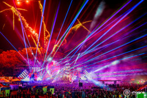 Purple and orange lights, lasers and fireworks going off at the mainstage at Music Festival 2023