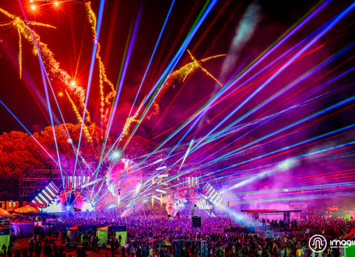 Purple and orange lights, lasers and fireworks going off at the mainstage at Music Festival 2023