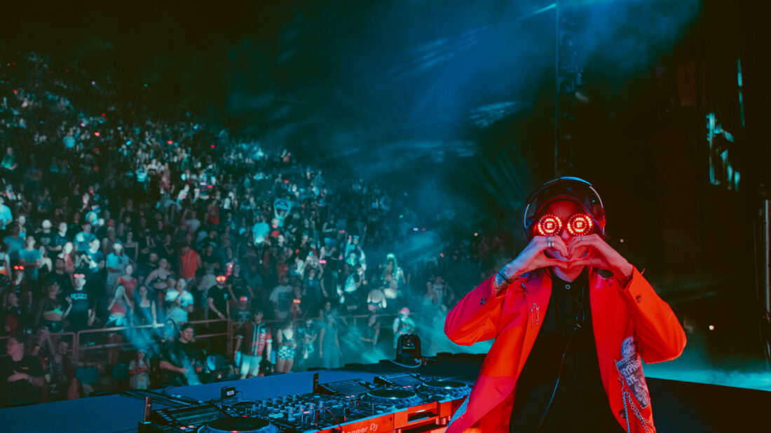 Photo of REZZ throwing up heart sign at Red Rocks