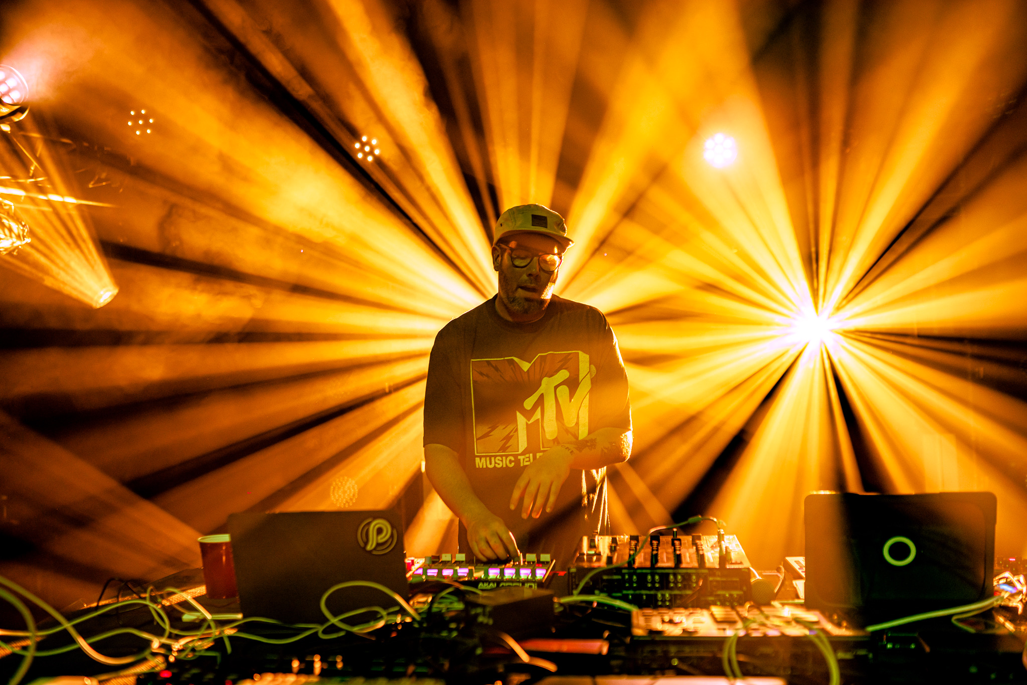 Late Night Radio live: DJ in front of gold lights mixing on a CDJ.