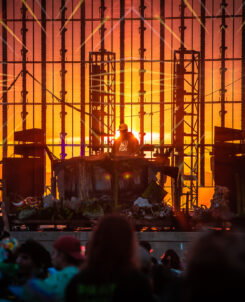 photo of sun setting behind a see through stage.