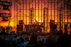 photo of sun setting behind a see through stage.