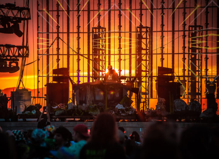 photo of sun setting behind a see through stage.