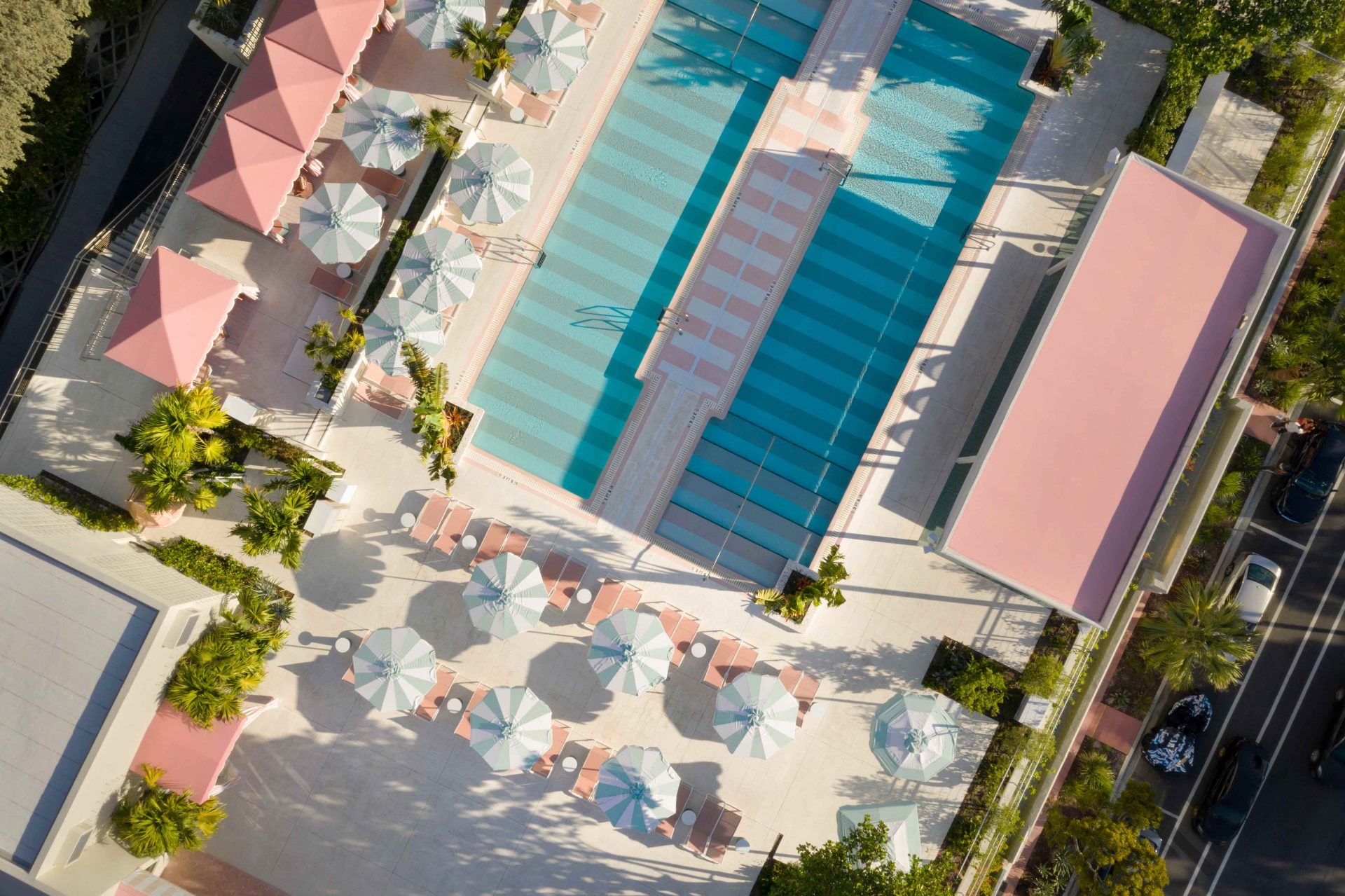 Ariel shot os Strawberry Moon pool in Miami — twin pools surrounded by pink buildings.