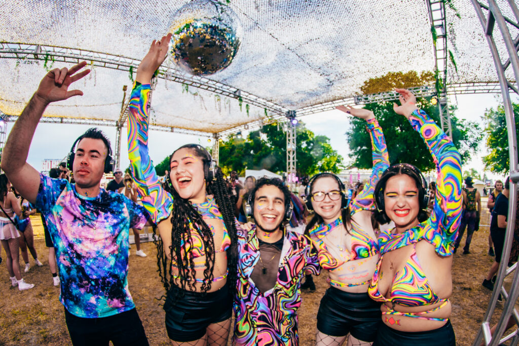 Group of people having fun and dancing at BREAKAWAY festival.