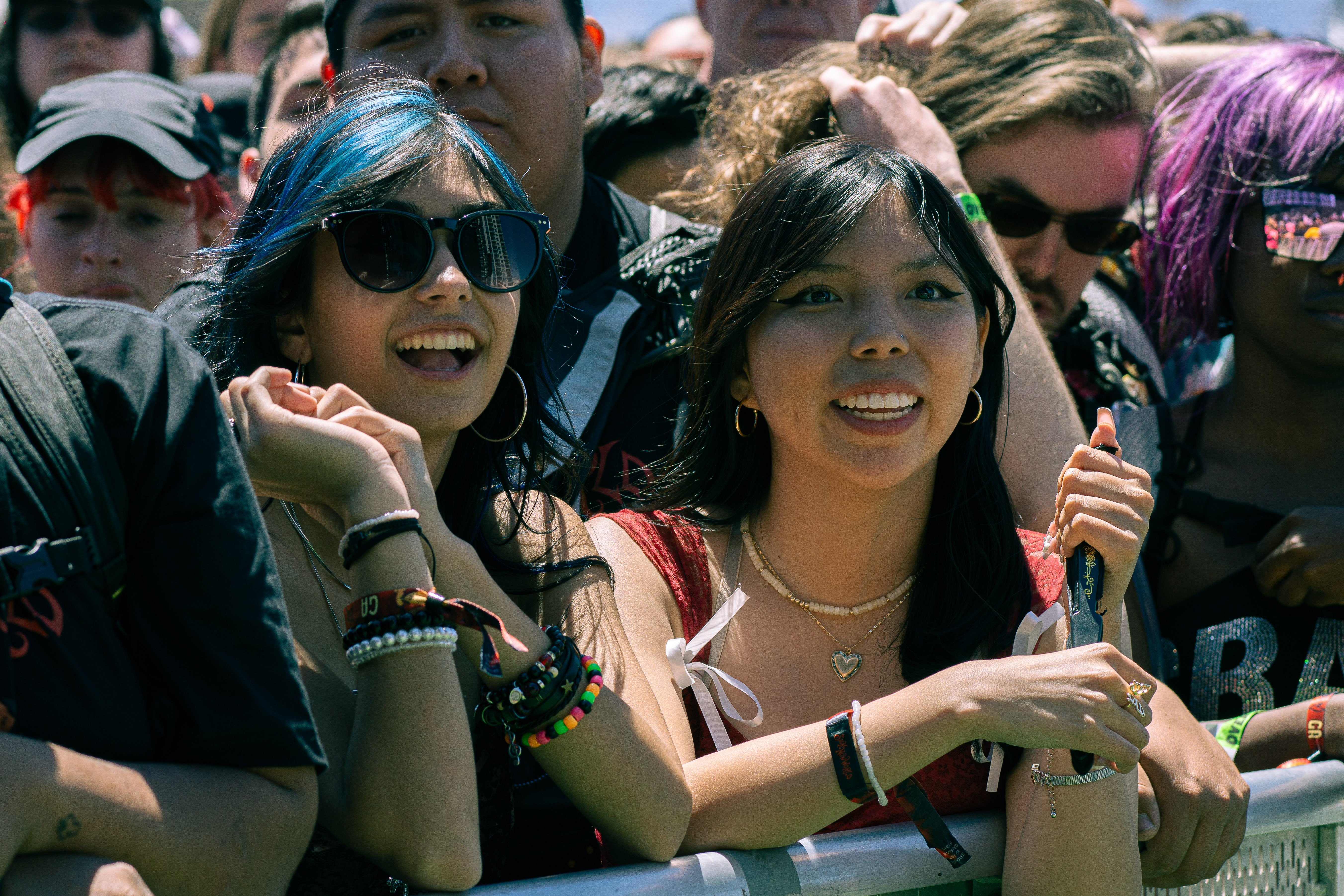 Two girls in the crowd enjoying themselves 
