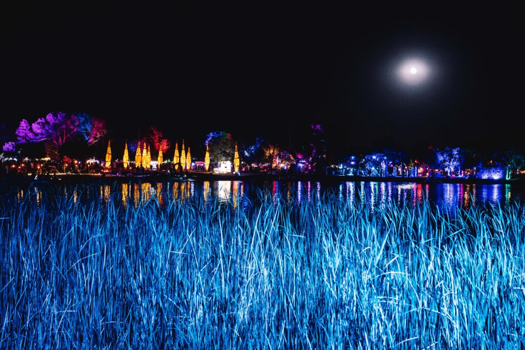 Lightning in a Bottle wide view of venue across the lake at night.