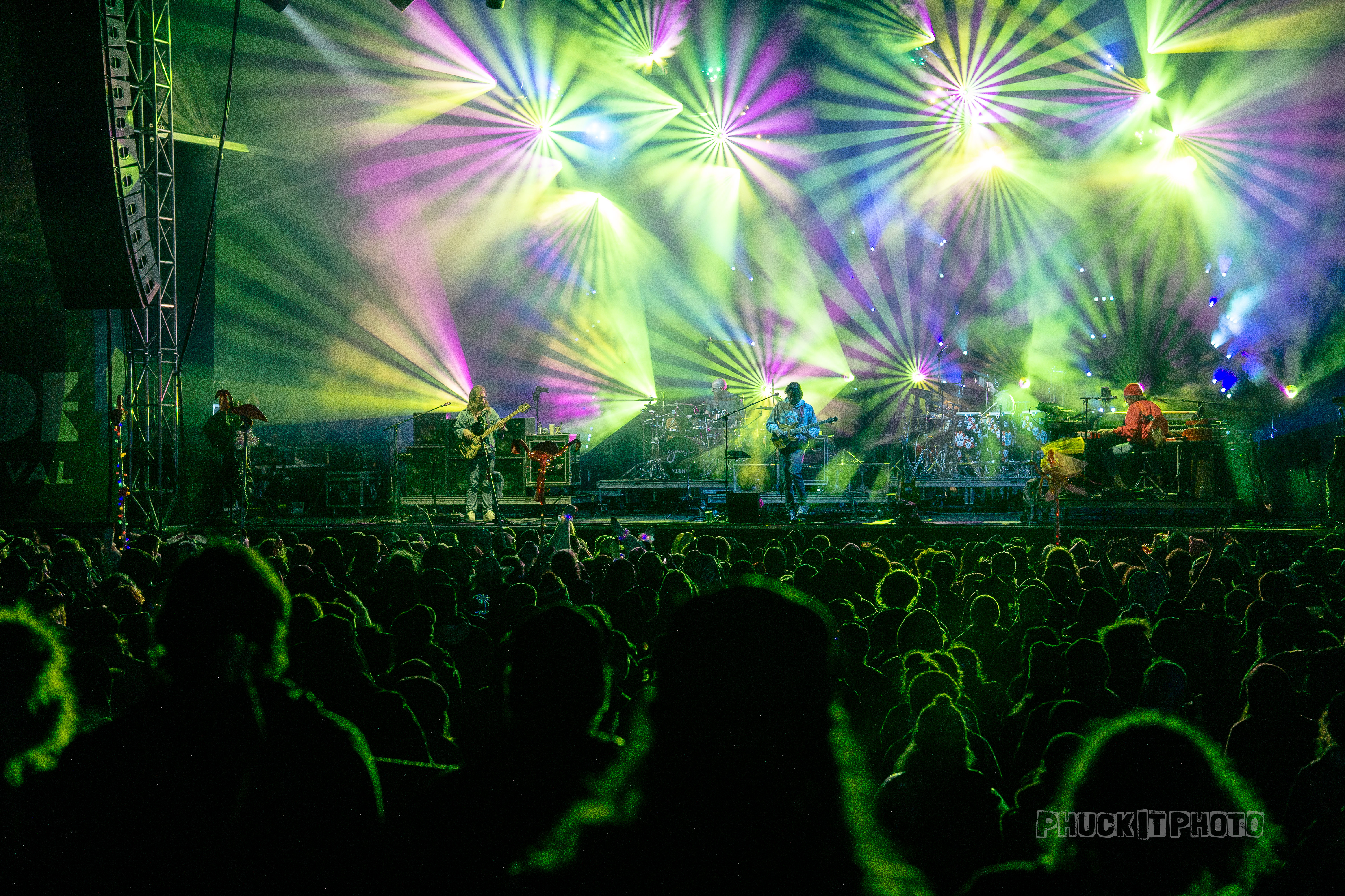 Colorful lights on a big stage at a music festival and large crowd