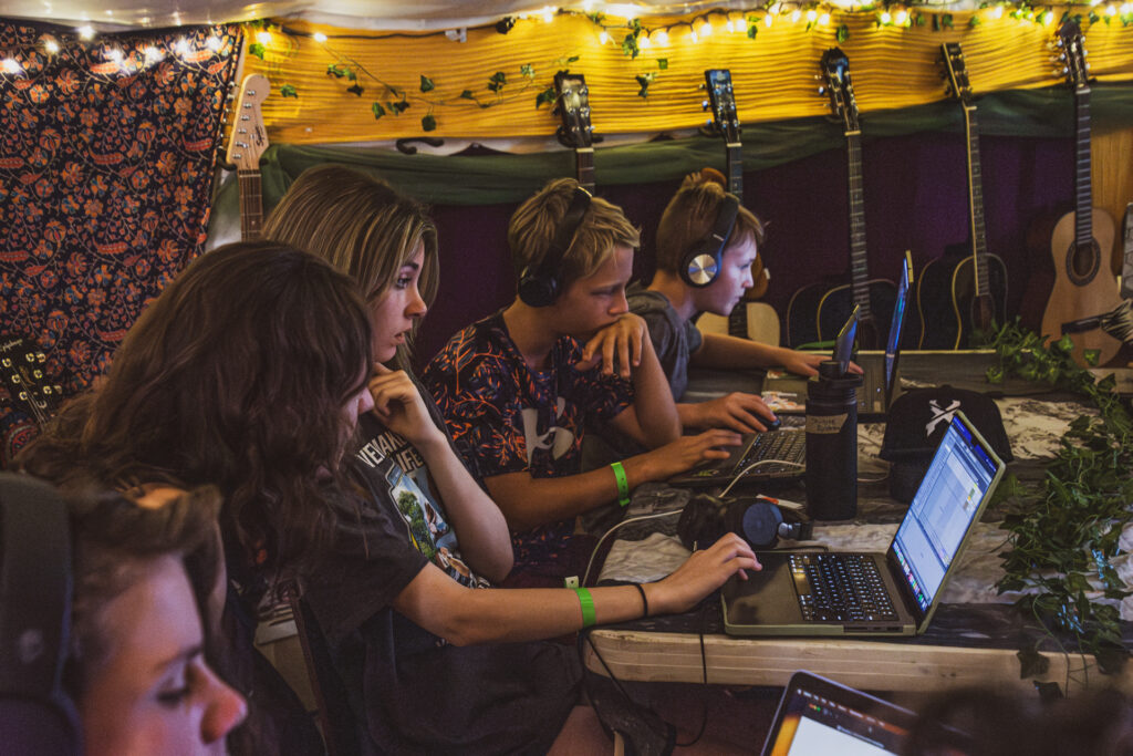 Kids at their computer learning how to produce music