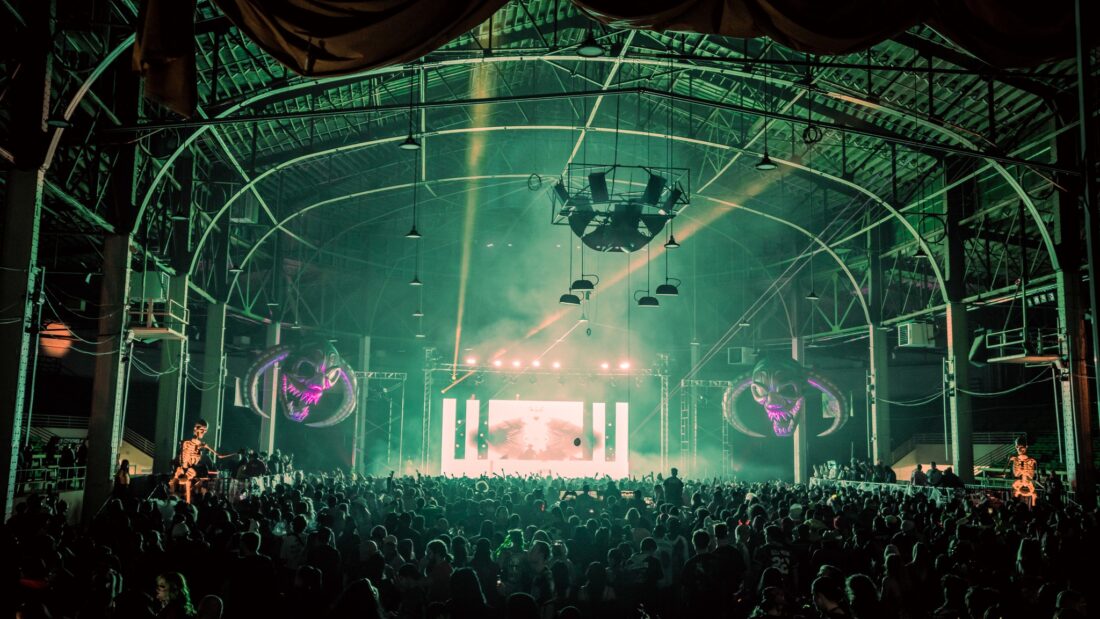 Supernatural festival in Denver, Colorado: big crowd standing in front of a stage with green lights.