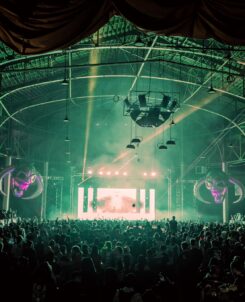 Supernatural festival in Denver, Colorado: big crowd standing in front of a stage with green lights.