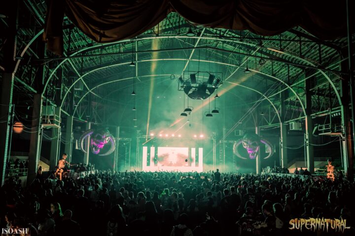 Supernatural festival in Denver, Colorado: big crowd standing in front of a stage with green lights.