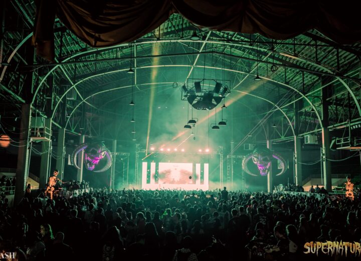 Supernatural festival in Denver, Colorado: big crowd standing in front of a stage with green lights.