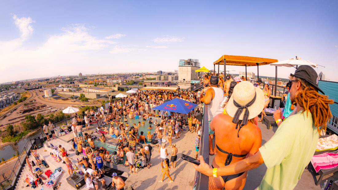 The Deep pool party. Overhead shot of people in the rooftop pool while music plays.