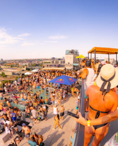 The Deep pool party. Overhead shot of people in the rooftop pool while music plays.