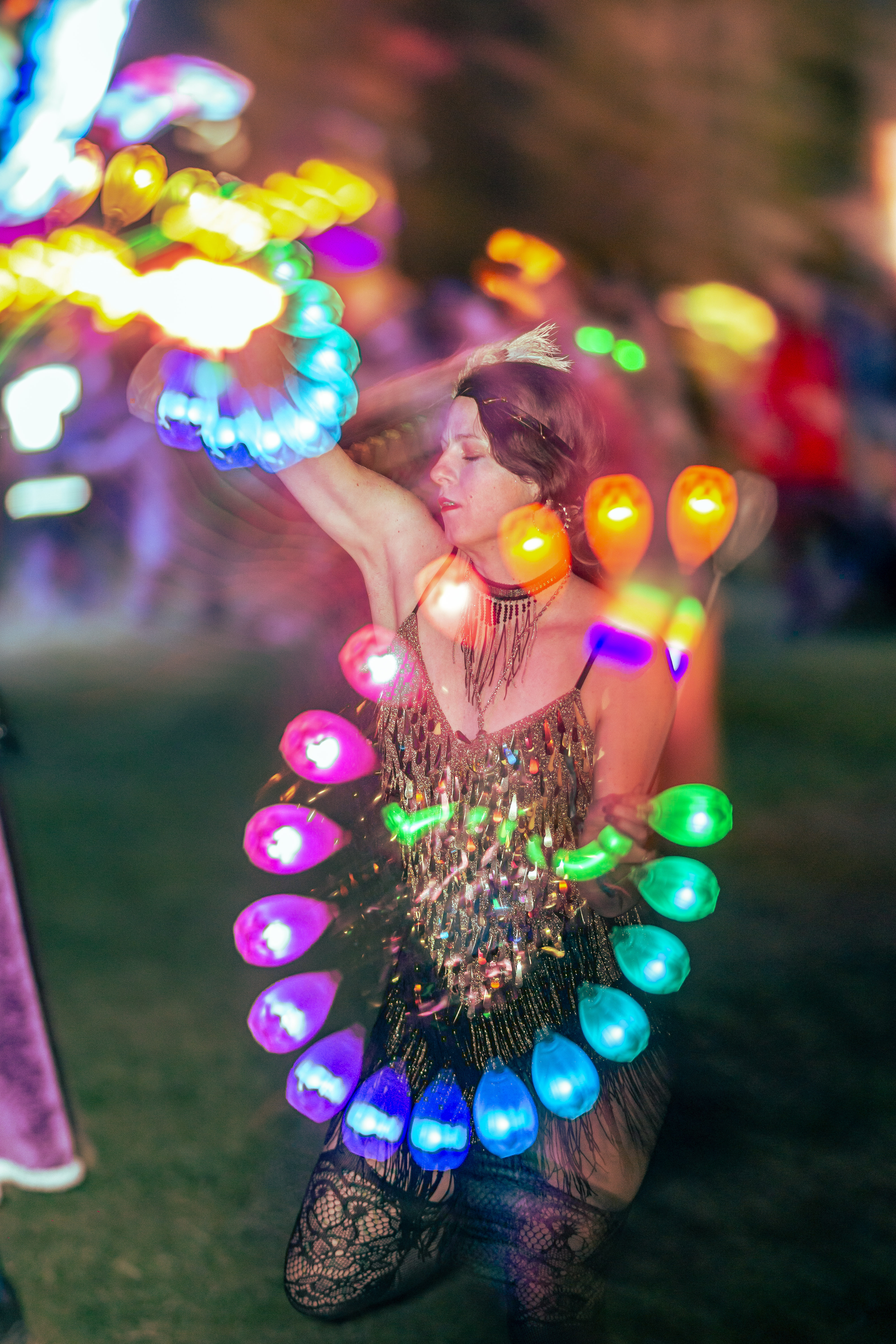 Woman using light up poi at music festival